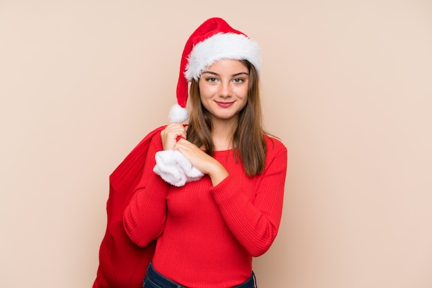 Young girl with christmas hat over isolated wall