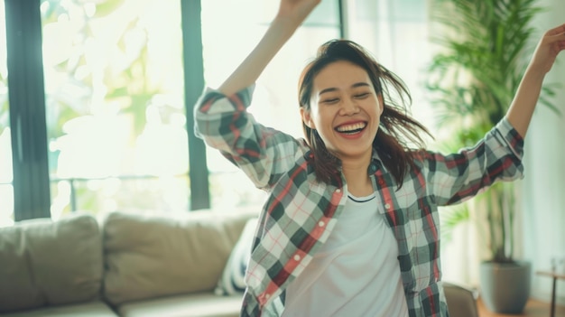 Photo young happy asian woman dancing at home