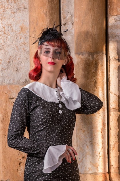 Young redhead girl on a retro vintage dress