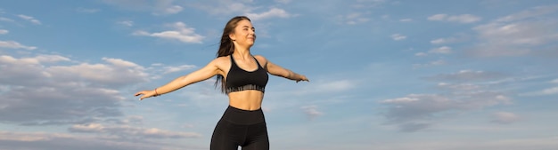 A young slim athletic girl in sportswear performs a set of exercises Fitness and healthy lifestyle