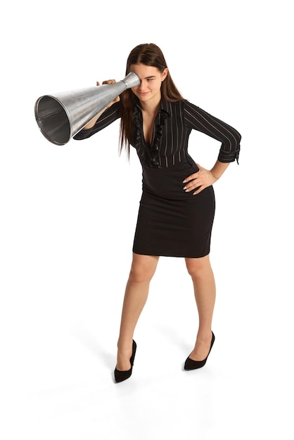 Photo young stylish girl assistant and secretary looking through huge megaphone isolated over white