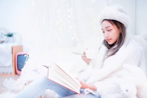 Young woman enjoying winter season. Relaxing and lifestyle on Christmas holiday at home.