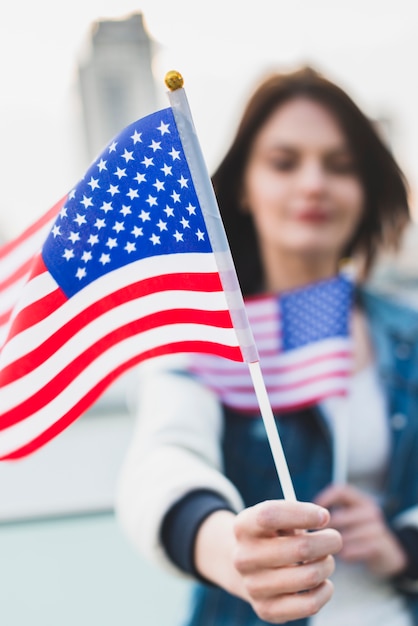 Young woman holding American flags