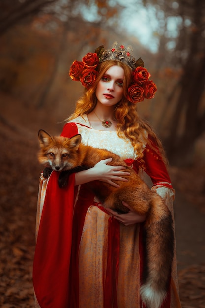 A young woman in medieval red dress with a fox
