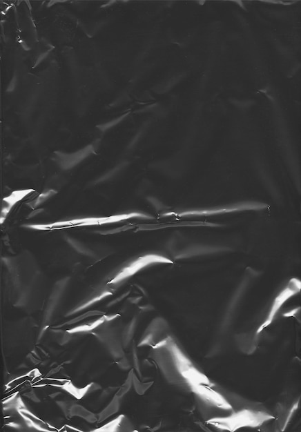 PSD a black and white photo of a shiny plastic bag with a drop of water on it