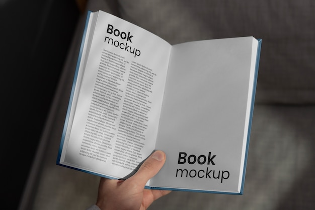 Book mock-up hand held by person