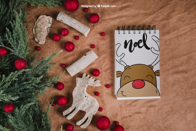 PSD christmas mockup with notepad next to balls and reindeer