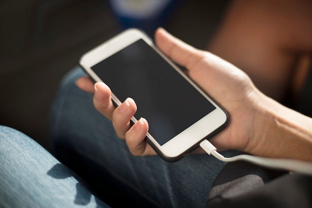 PSD close up of hands charging mobile phone