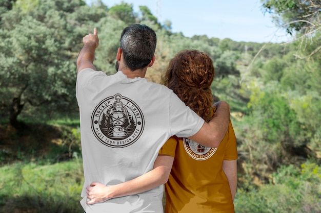 Couple outdoors in nature wearing t-shirts mock-up