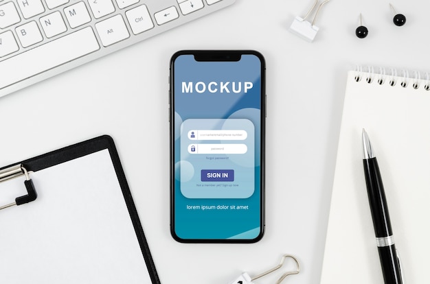 Flat lay smartphone mock-up with clipboard and pen on desk