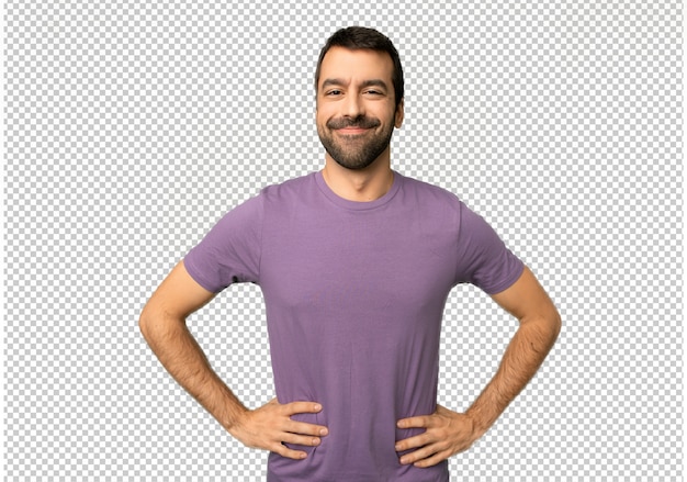 Handsome man posing with arms at hip and laughing looking to the front