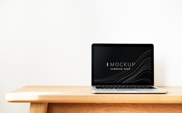 Laptop screen mockup on a wooden table