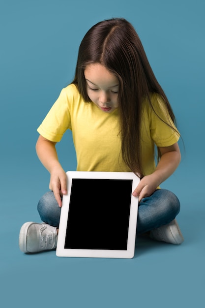 Little girl holding a blank tablet