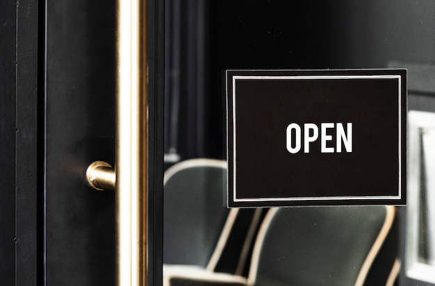 PSD open sign mockup on the door of a cafe