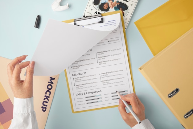 Person holding document mock-up with clipboard