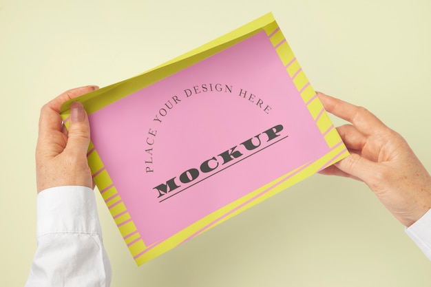 Person holding document mock-up with clipboard