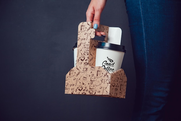 a person holds a coffee cup with a lid that says coffee on it