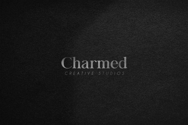 PSD silver logo mockup on dark texture background