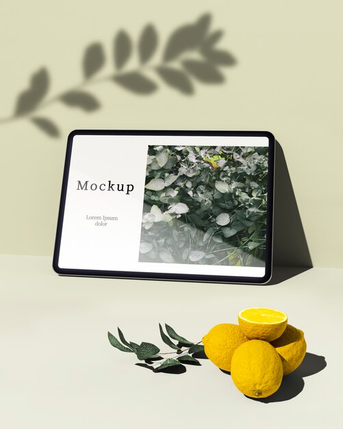 Tablet with citrus and leaves