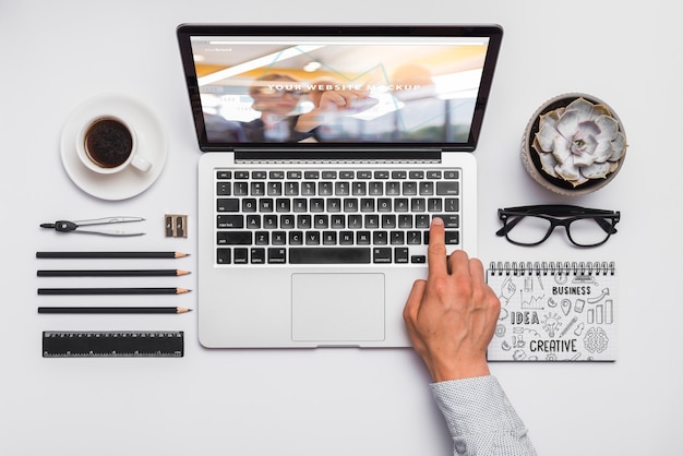 Top view composition with laptop and office supplies