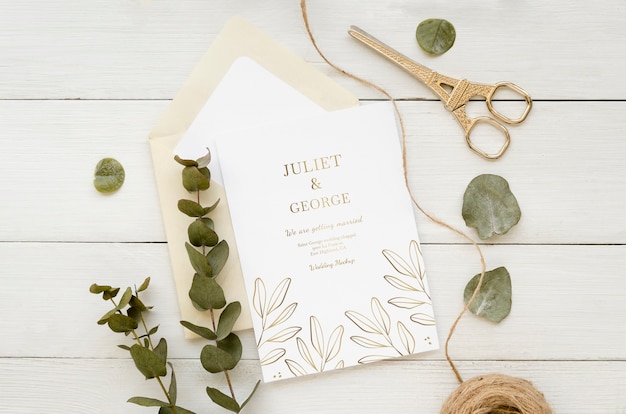 Top view of wedding card with plant and string