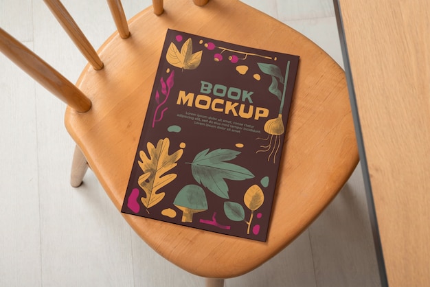 Top view on wooden furniture with book mockup