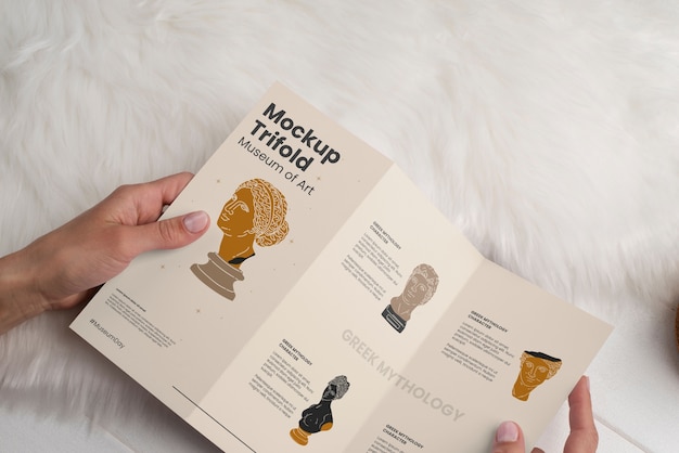 PSD trifold brochure mock-up held by person in hand
