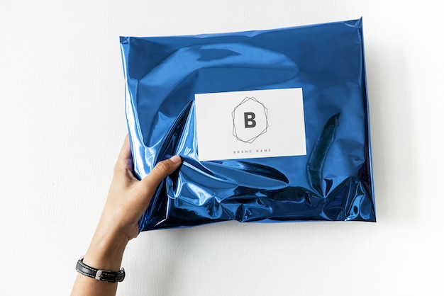 PSD woman holding up a package mockup