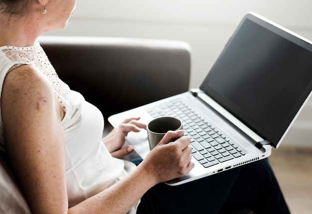 PSD woman using laptop on sofa