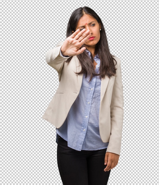 PSD young business indian woman serious and determined, putting hand in front, stop gesture, deny concept