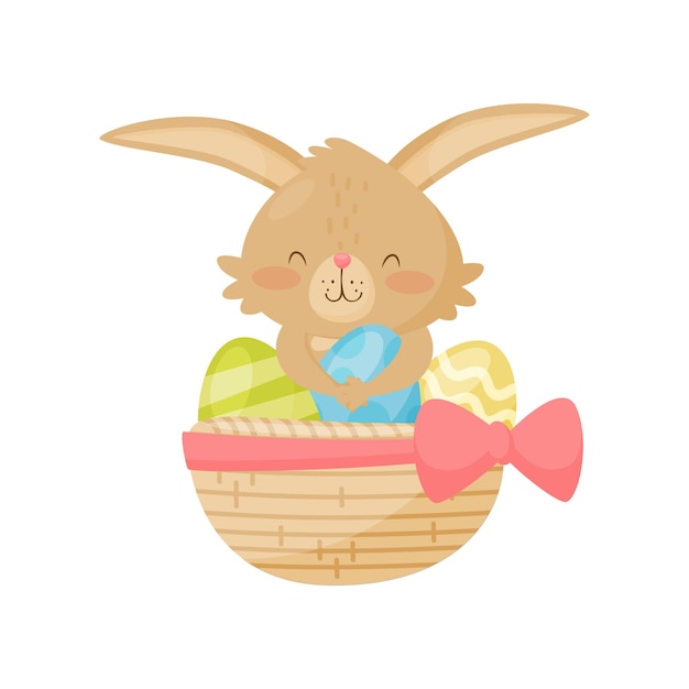 Adorable little bunny sitting in basket with colored Easter eggs Cute rabbit with pink cheeks Mammal animal with long ears Graphic element for holiday postcard Isolated flat vector illustration