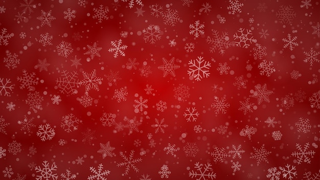 Christmas background of snowflakes of different shapes sizes and transparency in red colors