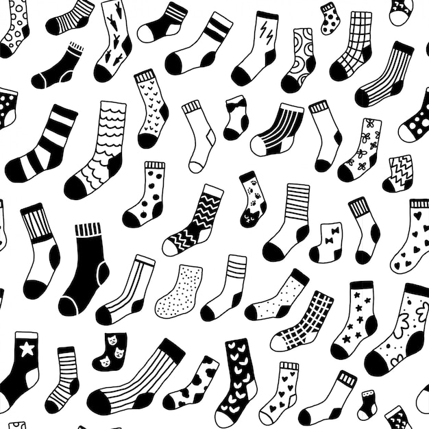 Seamless pattern with doodle black and white socks with different texture. Winter monochrome clothing items scandinavian style.