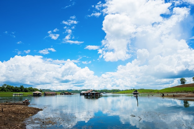 Dom tratwy na nabrzeżu jest otoczony niebieskim tłem nieba, prowincji Kanchanaburi, Tajlandia