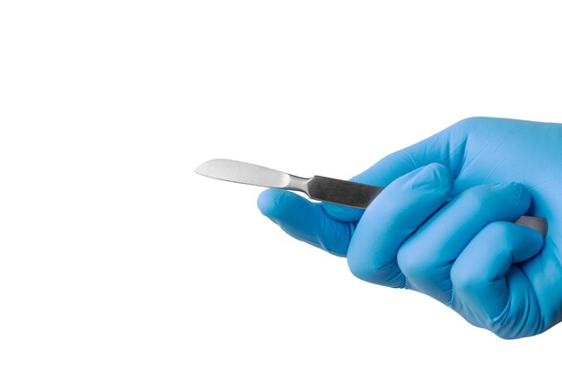 Scalpel chirurgical tenu à la main avec un gant