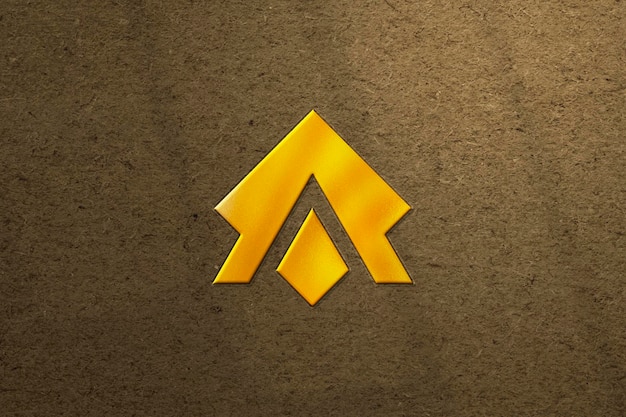 Maquete de logotipo dourado sobre fundo texturizado marrom