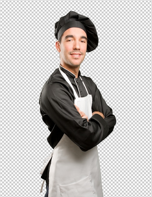 Orgulhoso jovem cozinheiro posando