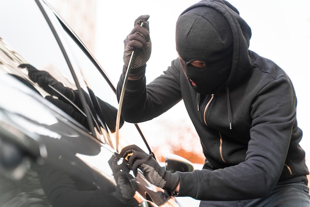 Close-up van man die probeert in te breken in een auto