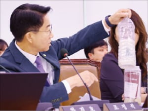 조정식 더불어민주당 의원이 8일 국회 외교통일위원회의 통일부 국정감사에서 탈북자단체가 서해를 통해 북으로 보내는 쌀이 담긴 페트병을 들고 질의하고 있다.   연합뉴스 