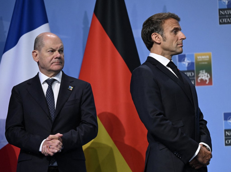 German Chancellor Olaf Scholz (left) and French President Emmanuel Macron attend an event with G7 leaders to announce a Joint Declaration of Support for Ukraine during the NATO Summit in Vilnius on July 12, 2023. 