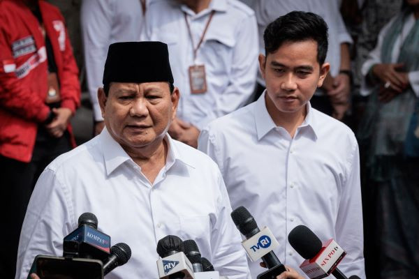 President-elect Prabowo Subianto (left) speaks to the media on April 24 with vice president-elect Gibran Rakabuming Raka as they arrive at the plenary session of the General Elections Commission (KPU), which confirmed their victory.