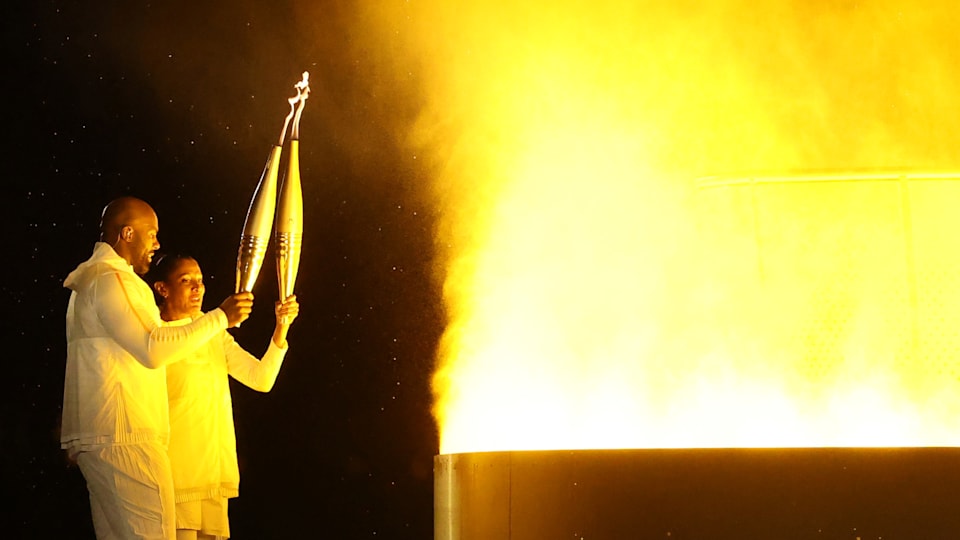 PARIS, FRANCE - JULY 26: Torch bearers French Athlete Marie-Jose Perec and French Judoka Teddy Riner light the Olympic Cauldron at the Gardens of the Tuileries during the opening ceremony of the Olympic Games Paris 2024 on July 26, 2024 in Paris, France.