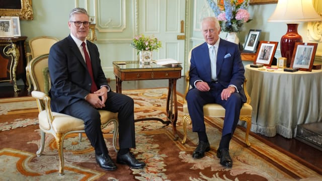 Britain's King Charles talks with Sir Keir Starmer during an audience at Buckingham Palace