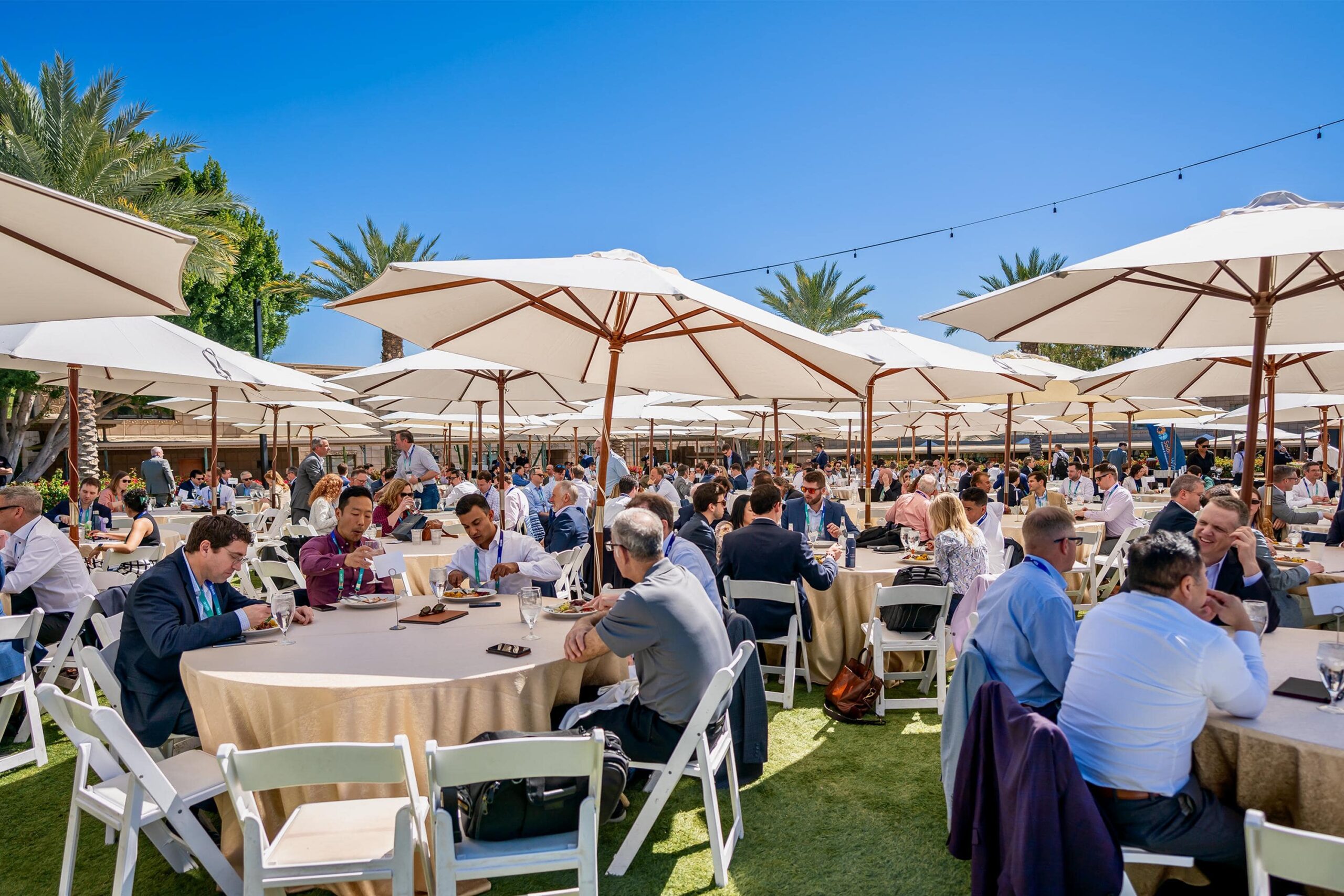 Outoor lunch tables with business professionals networking and eating lunch