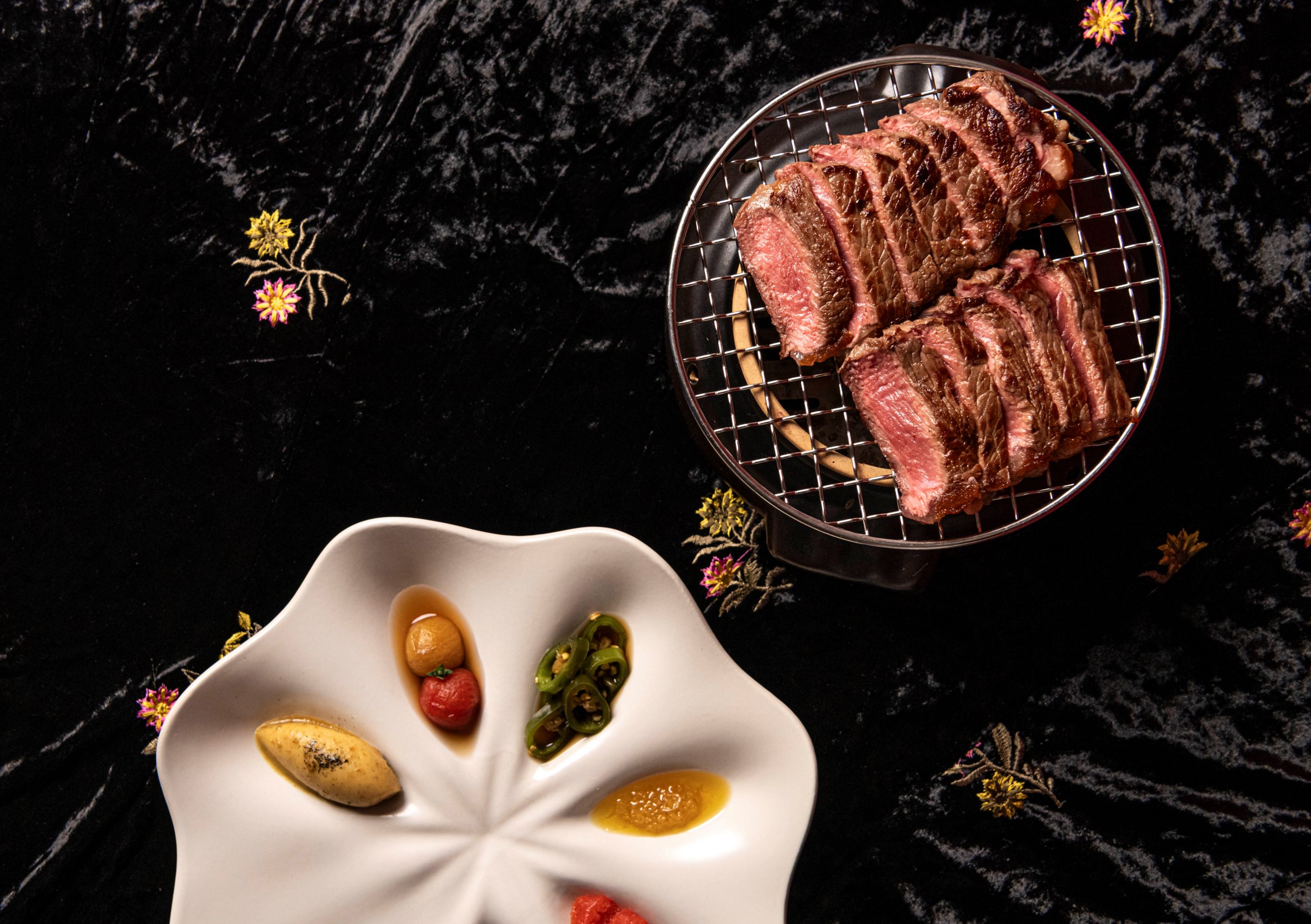 KBBQ Korean Barbecue dry-aged rib-eye steak on the menus at Logo for Jang Korean and Japanese restaurant at the Royal Exchange in The City of London