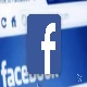 facebook logo with blurred facebook website in background