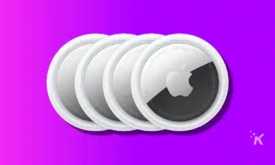 image of apple airtags on purple background