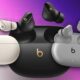 Three pairs of Beats wireless earbuds in different colors.