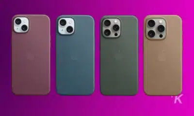 Four iPhones in different colors on purple background.