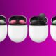 Four earbud pairs in cases, on magenta background.